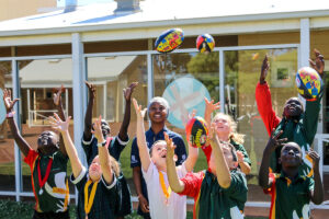 School kids with footballs