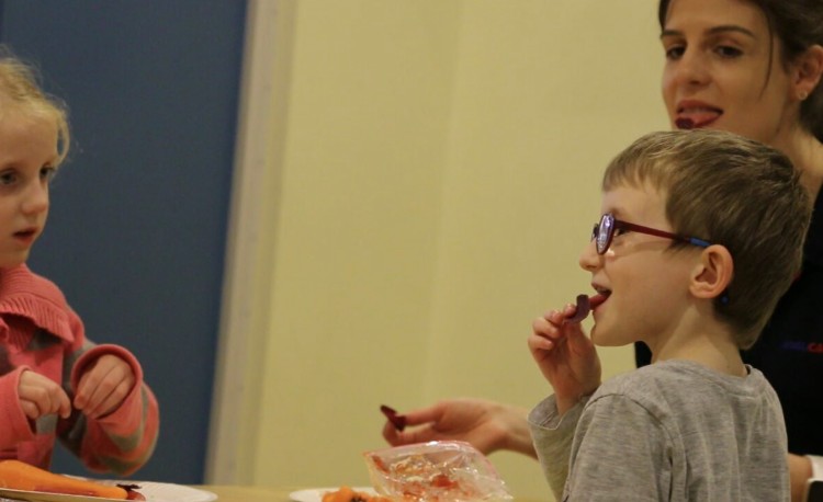 Ted and sister Lauren getting comfortable with some new foods, in this case a vege chip.