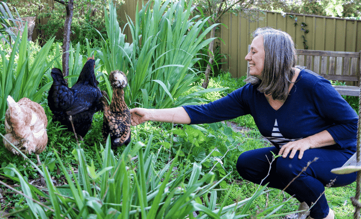 Elly pictured in her garden with her chickens