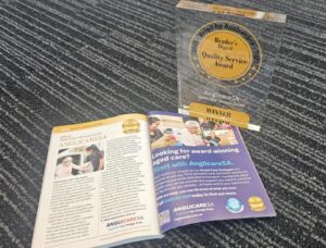 open magazine sitting on the carpet next to award