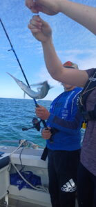 Man catching fish on fishing rod