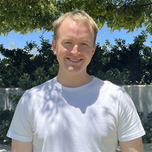 Man standing in front of bush