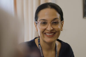 A photo of Rabina smiling and looking at the camera.