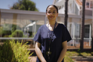 A photo of Rabina standing up outside AnglicareSA Residential Aged Care.
