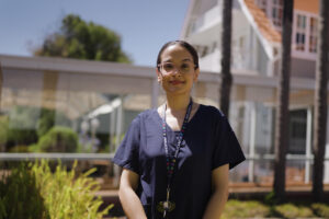A photo of Rabina standing up outside AnglicareSA Residential Aged Care.