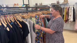 Woman looking through clothing rack