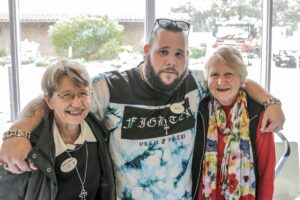 Volunteer Cameron with customers