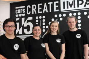 Four coffee baristas pose