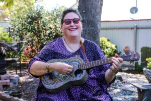 Volunteer Jenny with a ukulele