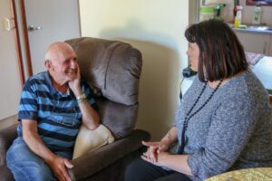 Alf on the couch with a support worker