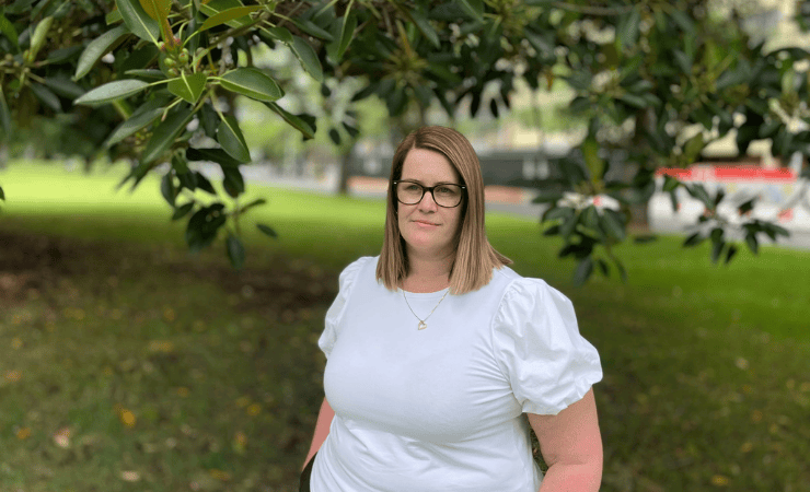 Hazel in a white blouse standing in the garden