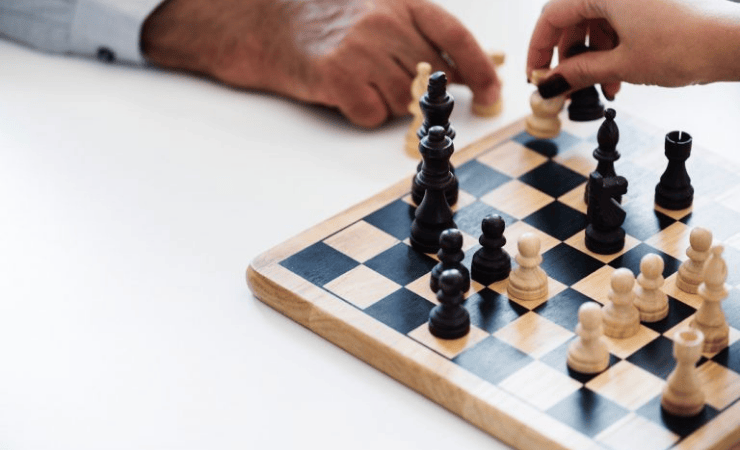 Chess board and hands of two people playing chess