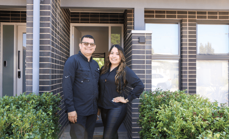 Roberto and Isneida stand proudly outside their home business. Their focus now: giving back.