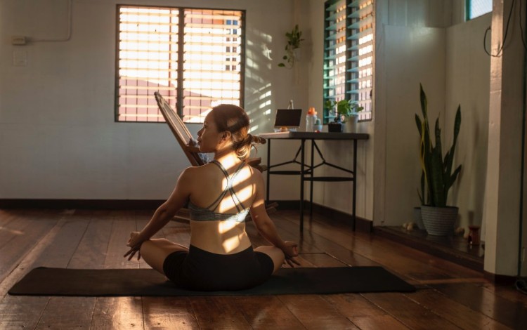 Lady doing yoga on a mat
