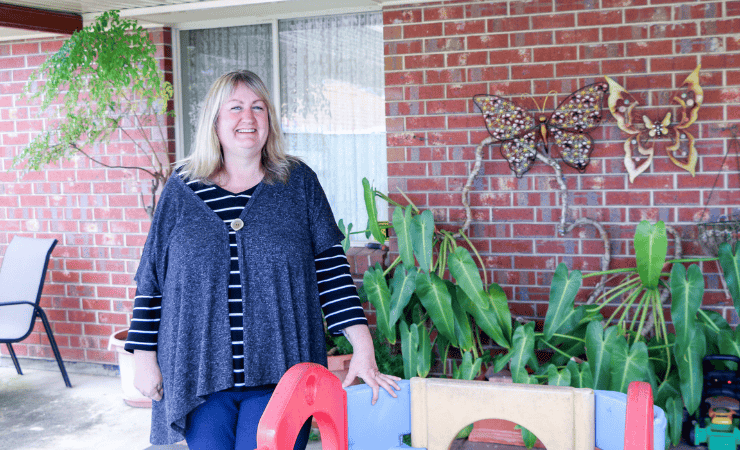 Wendy standing with a kids play device