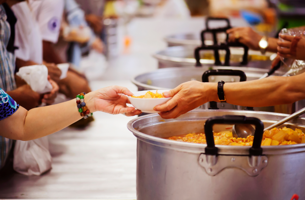 A person serving food in a food barn
