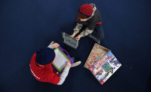 birds eye shot of 2 children playing board games