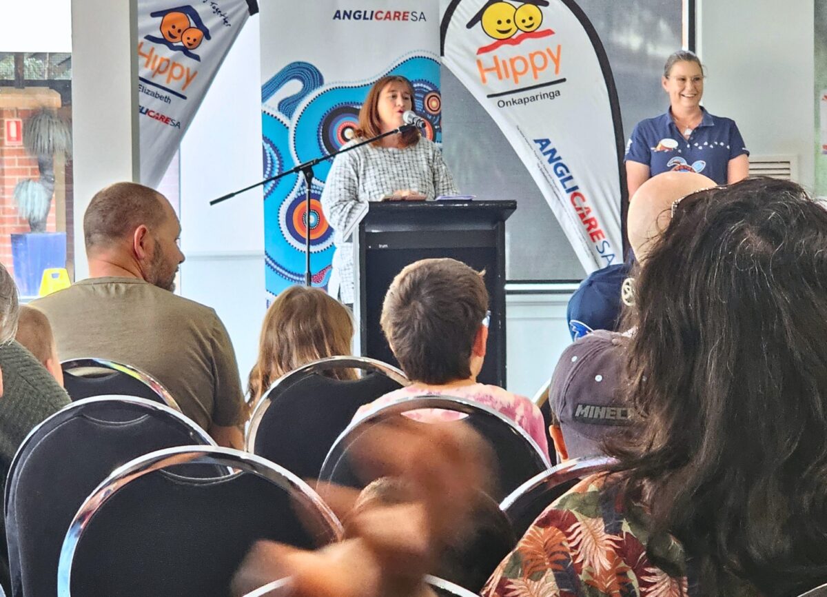 Sue Christophers speaking at the HIPPY graduation ceremony with families sitting in the audience