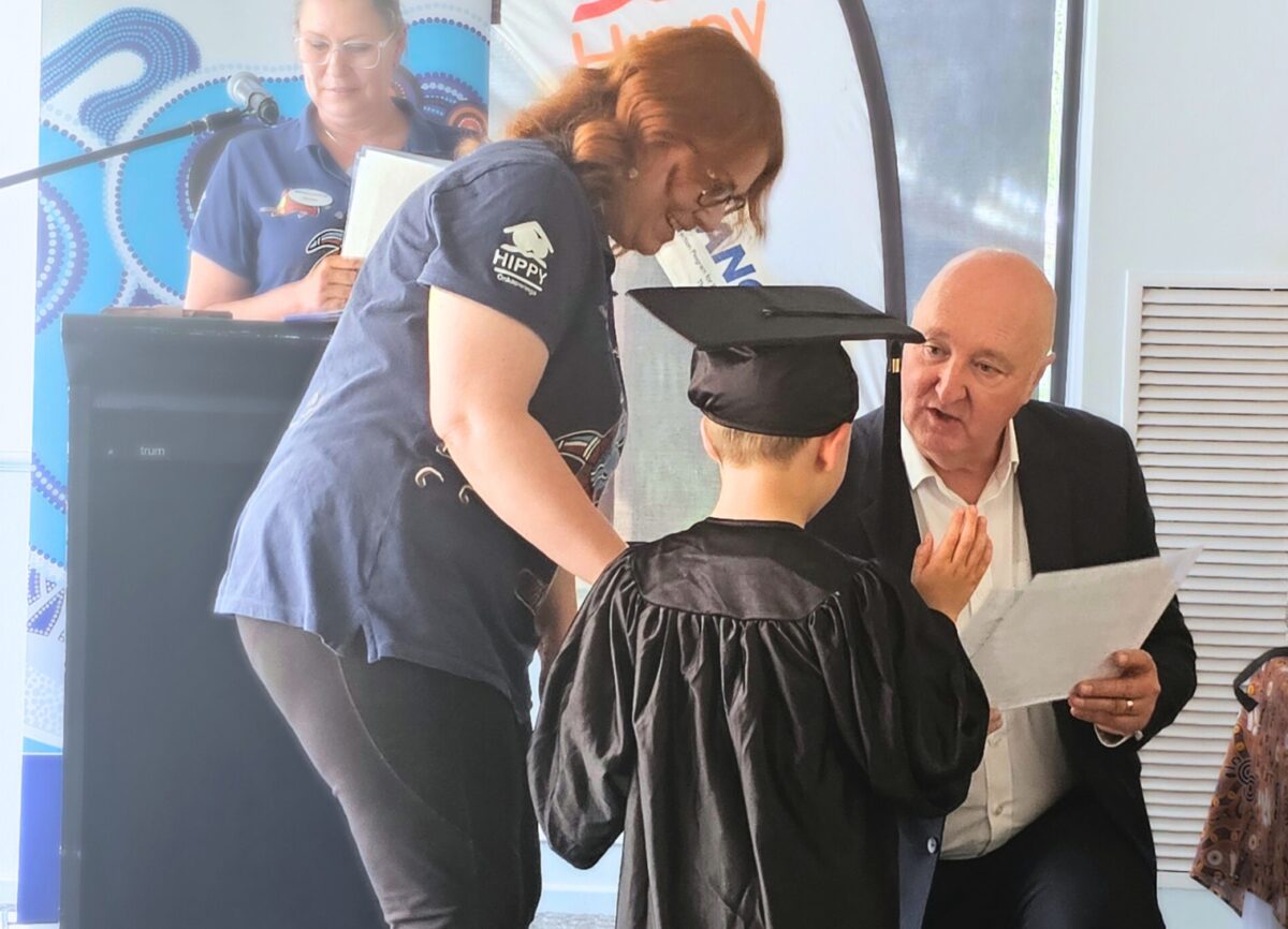 Ian Dillon gives a certificate to a graduate