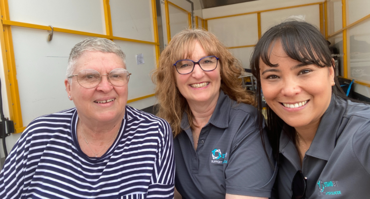 Country Arts SA stage manager Monica Hart with AnglicareSA’s Tracey Wanganeen and Anne Evans sit together smiling.