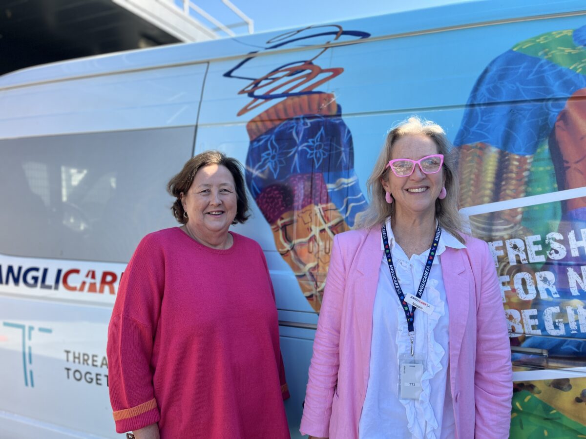 Mary-left-and-Maggie-right-Thread-together-volunteers stand in front of the Thread Together mobile van. 